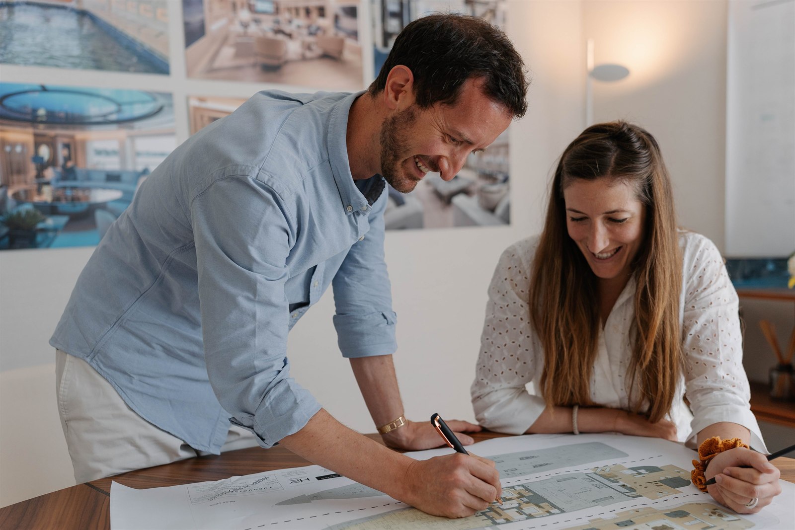 Two H2 Yacht Design designers reviewing a superyacht general arrangement together in the studio