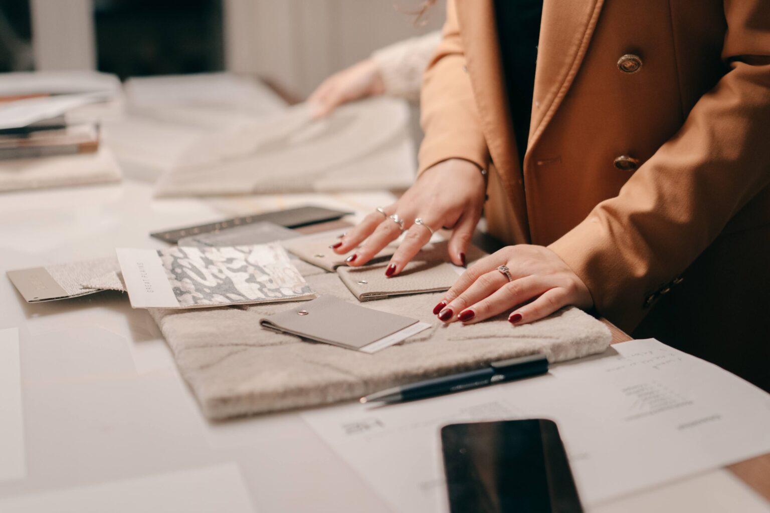H2 designers reviewing fabric and material samples — procurement and owners supply